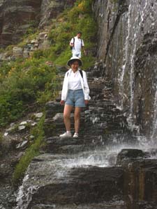 Hikers Walking Through A Waterfall